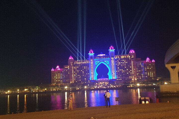 Experience the stunning lights of Atlantis the Palm where architectural brilliance meets dazzling reflections creating an unforgettable backdrop for an evening stroll along the beach.
